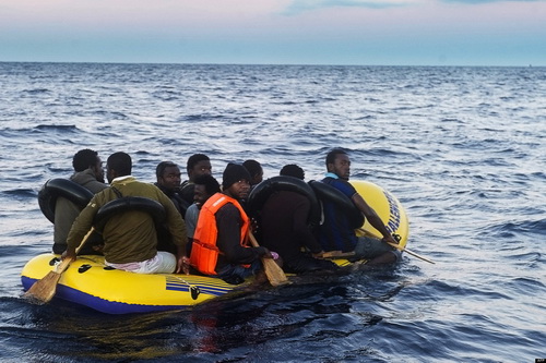 Would-be immigrants row in an inflatable boat off the Spanish coast, six miles (9.65 kilometers) from Tarifa, on November 13, 2012. Spanish emergency services and the Red Cross intercepted the boat carrying 10 sub-Saharan would-be immigrants off the Spanish coast, near Tarifa (southern Spain), as the country faces several weeks to an influx of illegal immigrants trying to cross the Strait of Gibraltar. AFP PHOTO / MARCOS MORENO